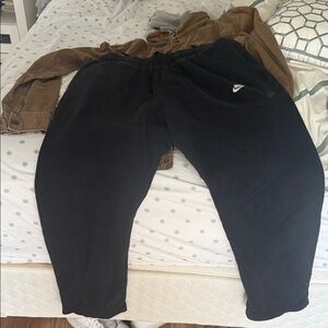 Nike Black Joggers with White Logo with a small bleach stain